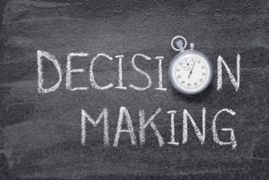 The phrase "Decision Making" written with chalk on a blackboard.